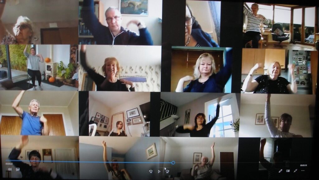 Participants take part in a Zoom chair-based exercise class